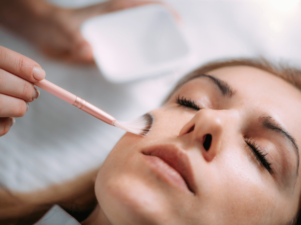Woman receiving professional chemical peel treatment at Exhale Skin Studio in Leawood KS