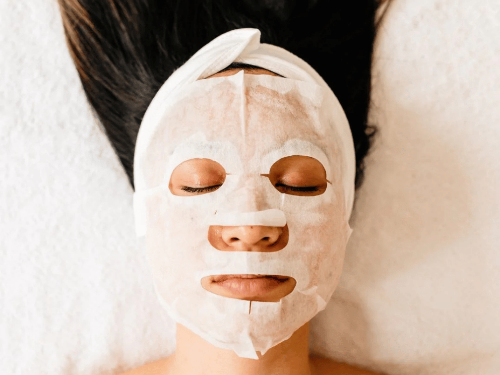 Woman getting a Glass Skin facial treatment for hydrated glowing skin at Exhale Skin Studio in Leawood KS
