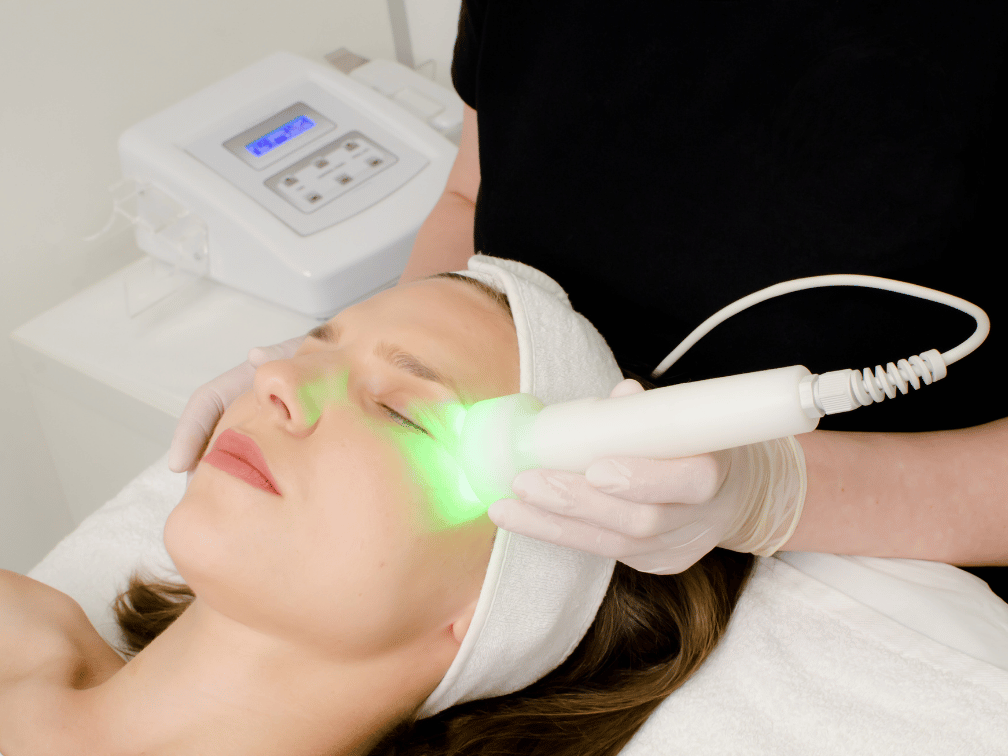 Client receiving LED light therapy facial for skin rejuvenation at Exhale Skin Studio in Leawood KS