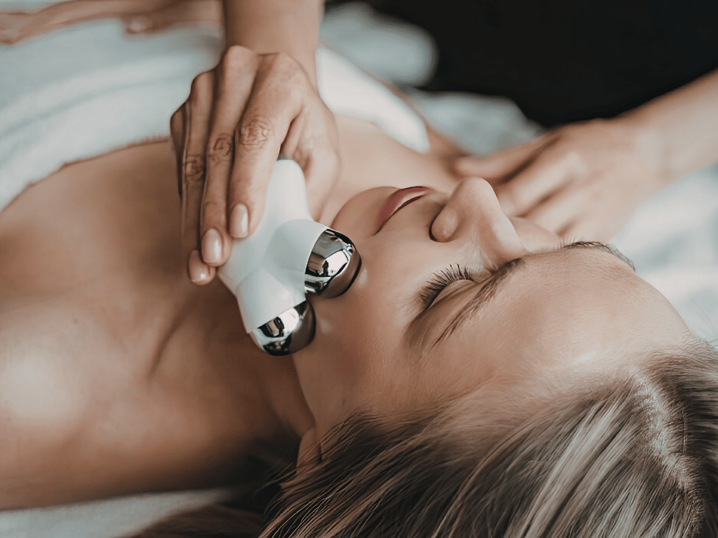 Woman receiving microcurrent facial to lift and tone skin at Exhale Skin Studio in Leawood KS